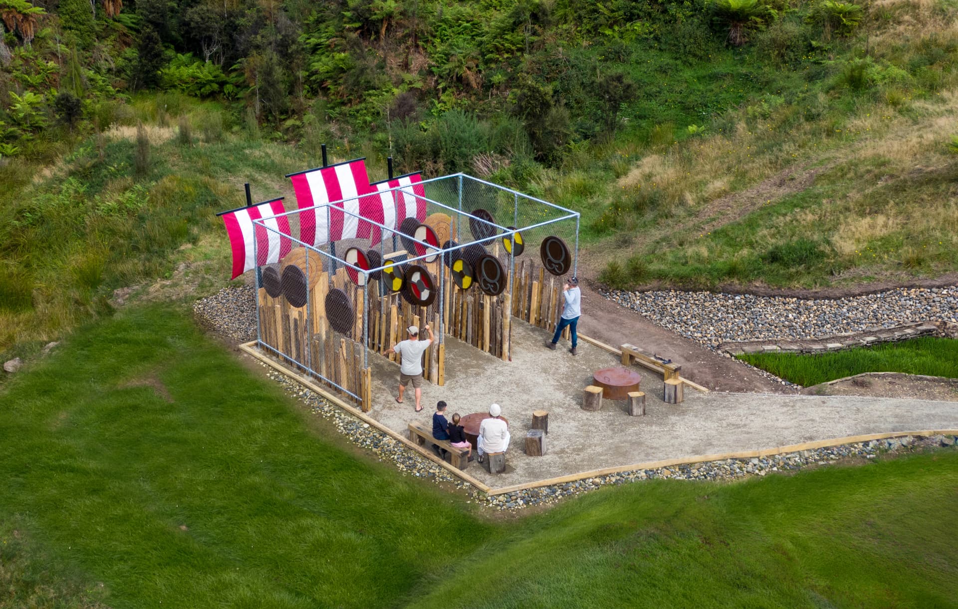 Aerial view of the axe throwing range with Viking sails and shield targets