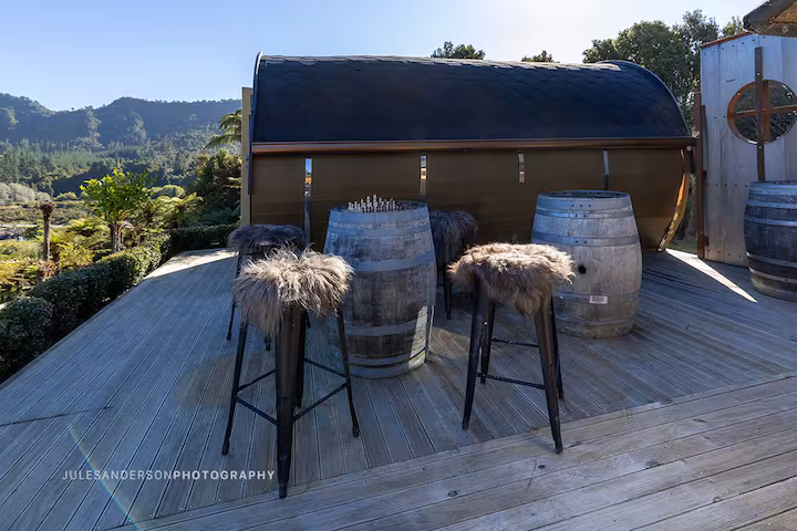 Odin barrel cabin exterior surrounded by native rainforest at Viking Village