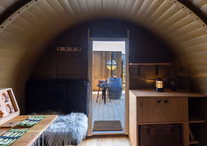 Interior detail of the Balder barrel cabin with warm timber lining and soft lighting